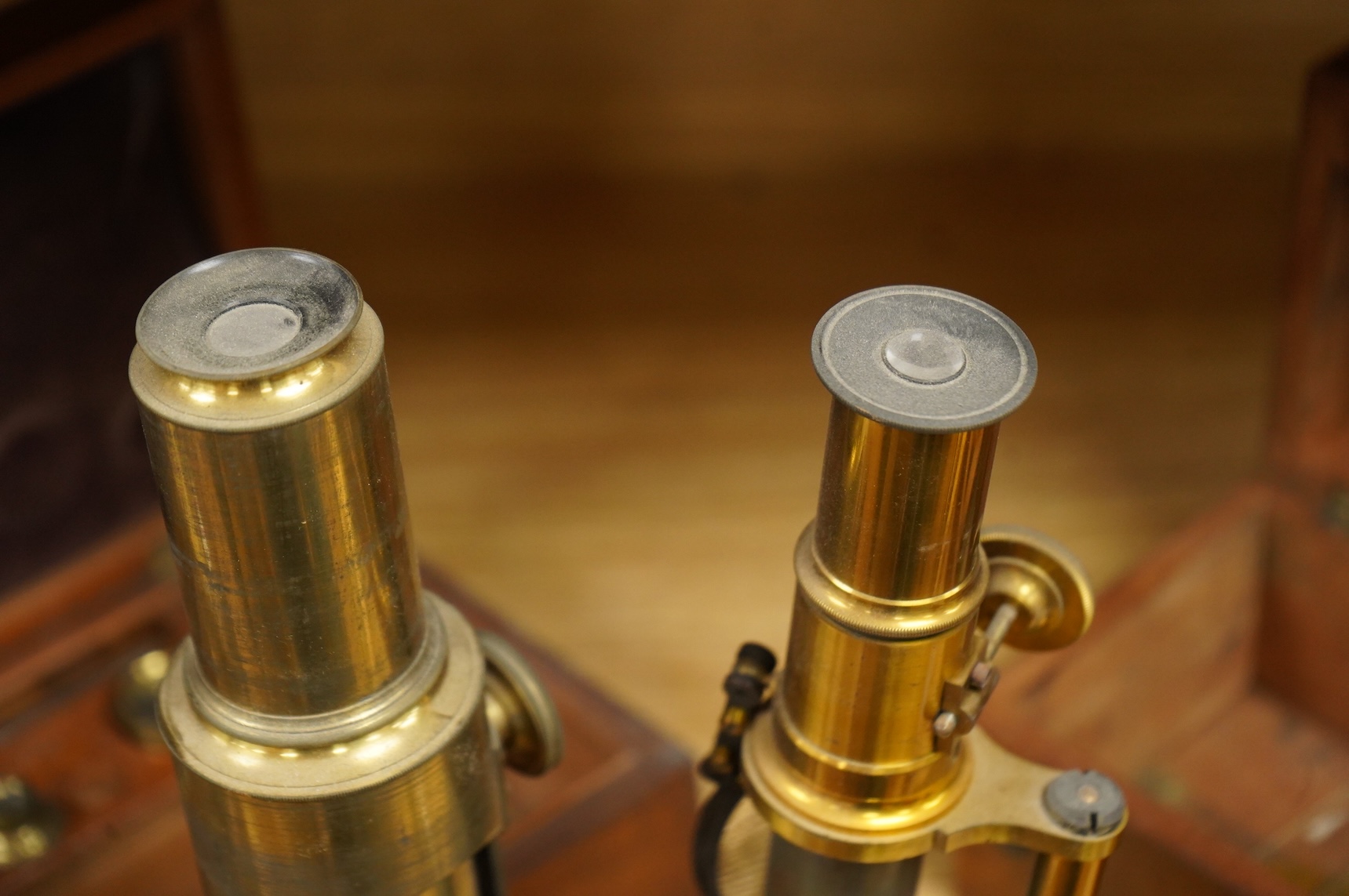 Two microscopes; an early 19th century Martin type brass compound monocular microscope, with five numbered objectives, specimen tube and hand magnifier, mahogany case 27cm wide, together with a late 19th/early 20th centu